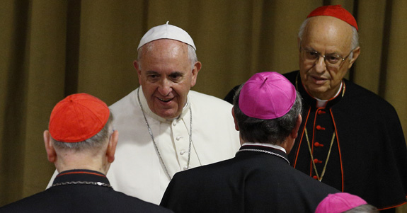 Pope Francis greets prelates as he arrives for the afternoon session on the first working day of the extraordinary Synod of Bishops on the family at the Vatican Oct. 6. (CNS photo/Paul Haring) See SYNOD-OPENING Oct. 6, 2014.