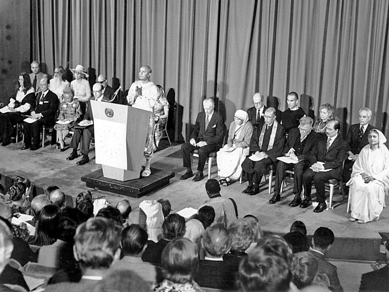 "Spiritaul teacher" Sri Chinmoy opens the first International Interfaith Conference at the UN in 1975. Mother Teresa can be seen on the front row, right side of the photo, second from the podium.